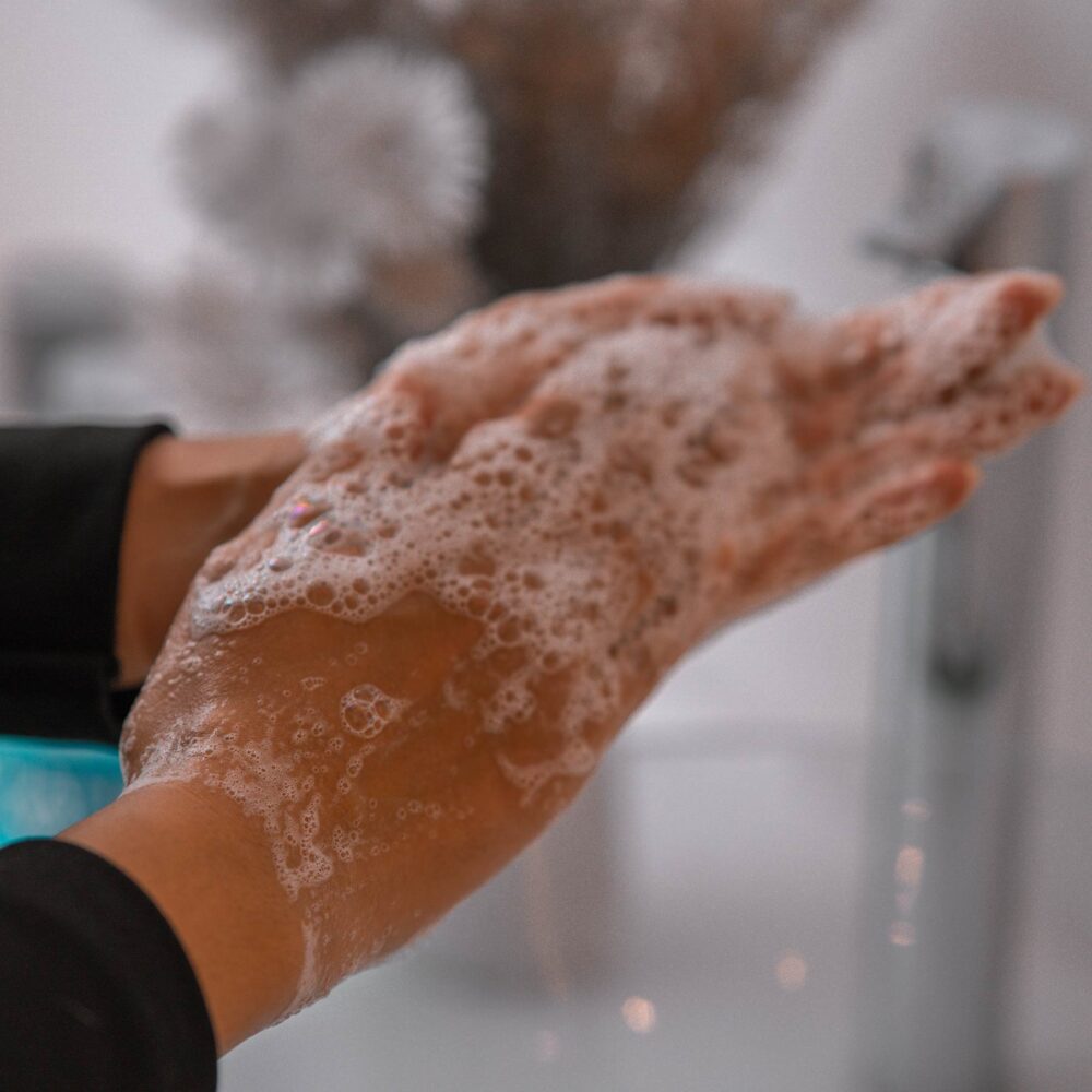 A woman lathers the Cleanser Intensive in her hands